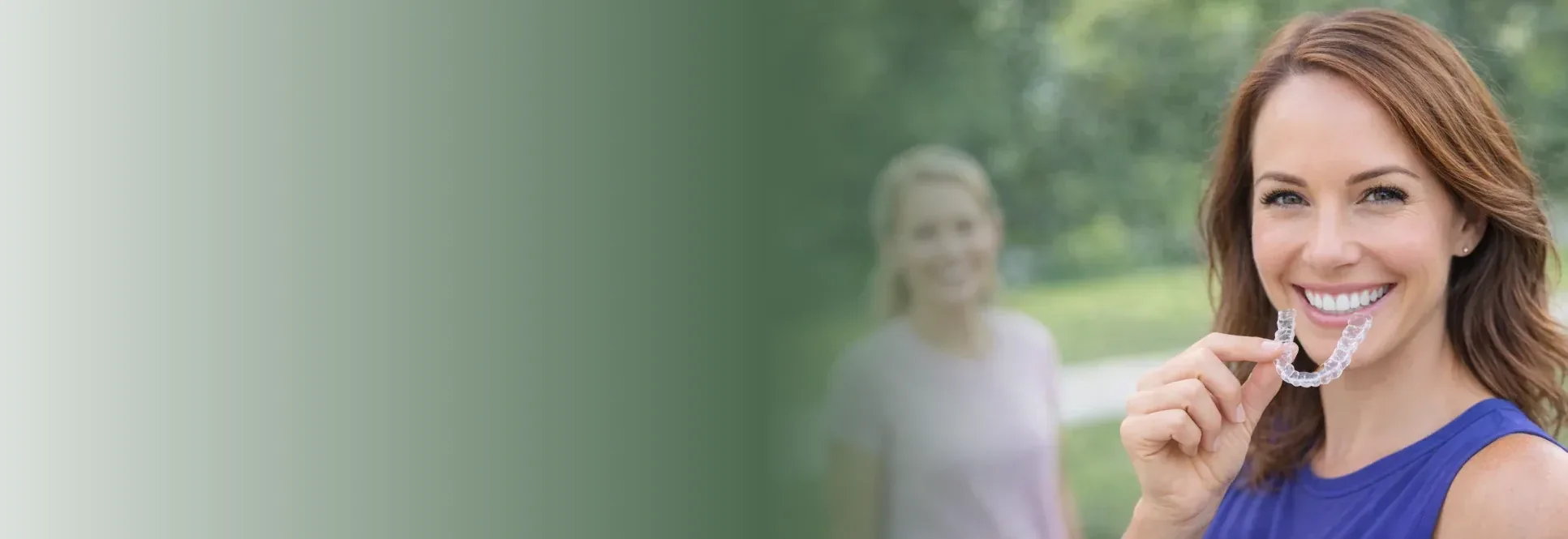 Woman holding invisalign aligner — Invisalign at PermaSmile! in Ottawa