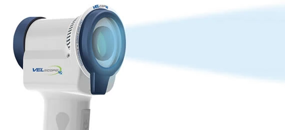 The handheld fluorescence light used to screen for oral cancer at a routine visit